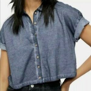 Free people cropped short sleeve blue distressed button up top. Size Small.